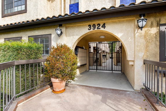 Front view of a building with an arched entrance and visible address number.