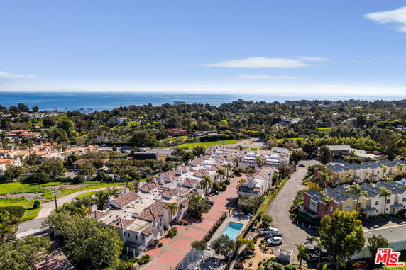 Panoramic view of residential area with ocean in the background.