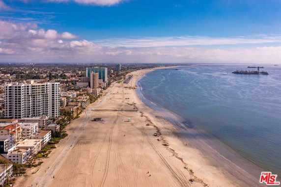 Panoramic view of beachfront buildings and coastline.