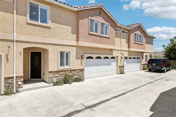 Front view of a two-story house with attached double garages.