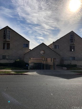 Front view of a residential building with a distinctive triangular roof design.