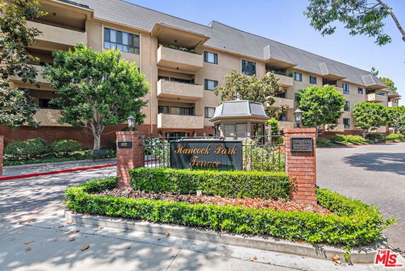 Front view of a multi-story residential building with balconies.