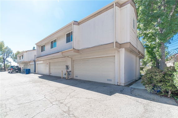 Front view of a two-story residential building with multiple garages.