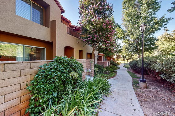 Exterior view of a residential building with a pathway and garden