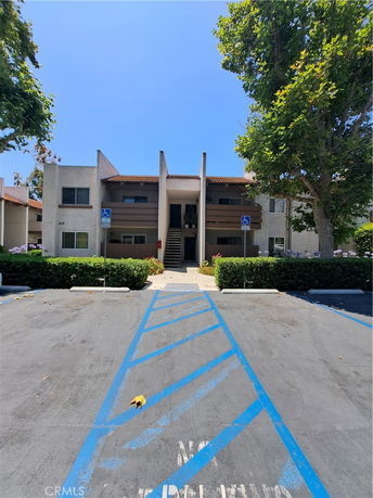 Front view of a multi-story building with a central staircase.