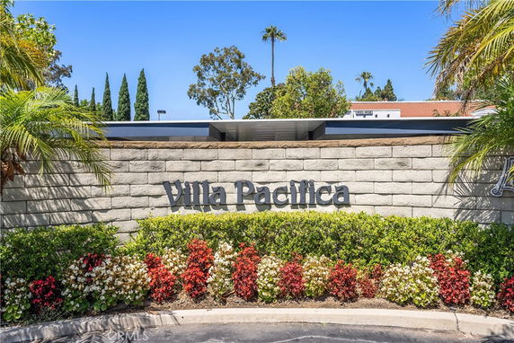 Front view of a building with a stone wall featuring the name 'Villa Pacifica'.