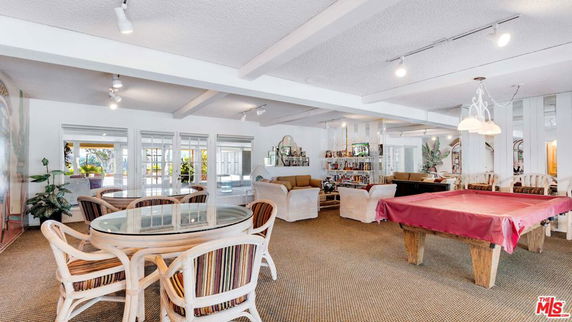 Indoor recreation area with seating and a pool table