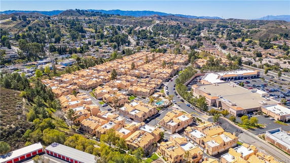 Wide-angle view of a residential area with numerous houses and surrounding landscape.