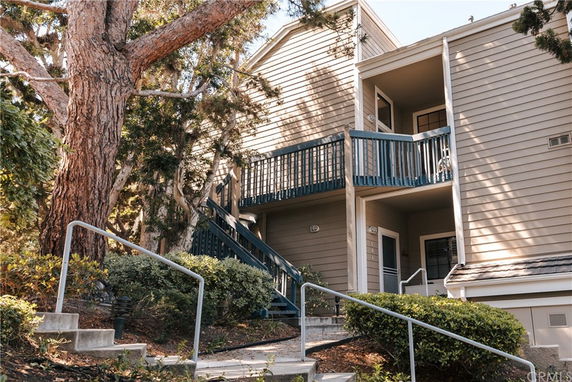 Front view of a multi-story building with exterior stairs and balconies.