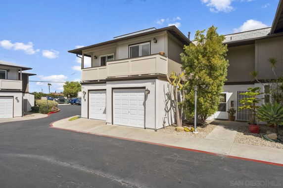 Front view of a multi-story house with an attached garage.