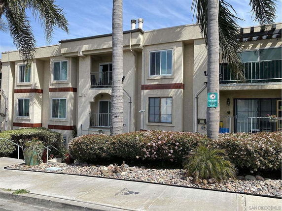 Front view of a two-story apartment building with balconies.