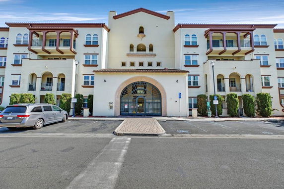 Front view of a multi-story building with balconies.