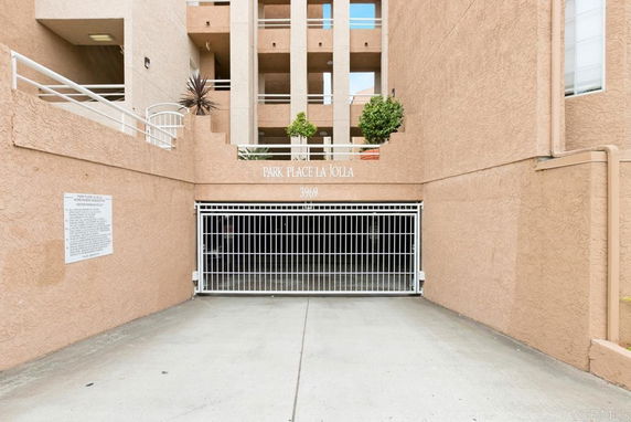 Entrance to a gated parking area of a residential building.