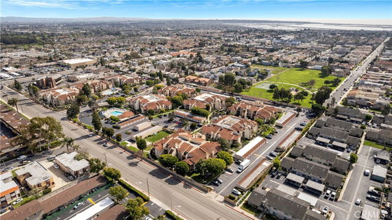 Aerial view of a suburban area with residential buildings, roads, and a park.