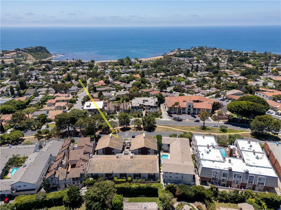 Panoramic view of residential area with ocean in the background.