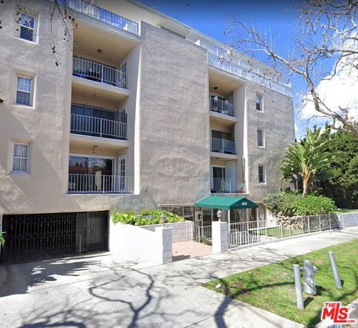 Front view of a multi-story residential building with balconies.