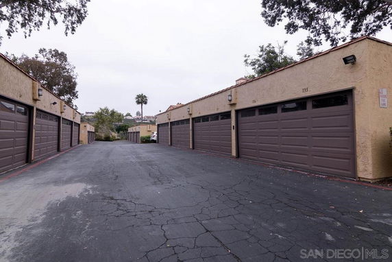 Outdoor parking area with multiple garages.