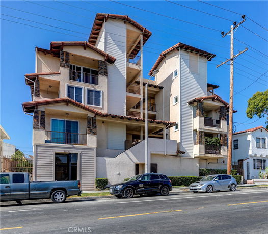 Front view of a multi-story residential building with balconies.