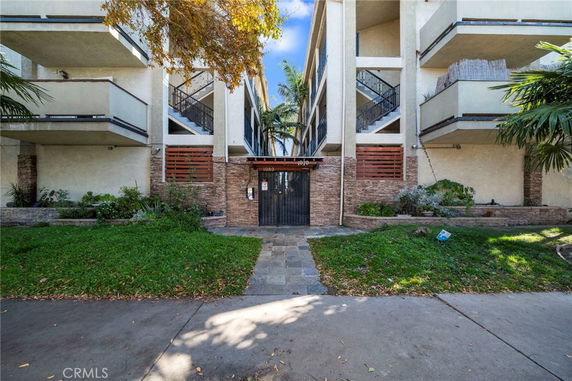 Front view of a multi-story residential building with balconies.
