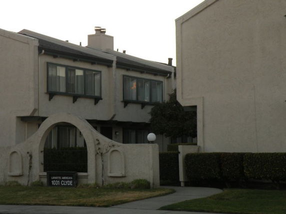 Front view of a multi-story building with an archway entrance.