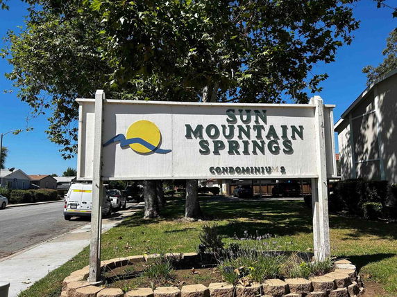 Front view of Sun Mountain Springs Condominiums sign.