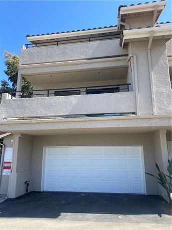 Front view of a multi-story house with a garage.