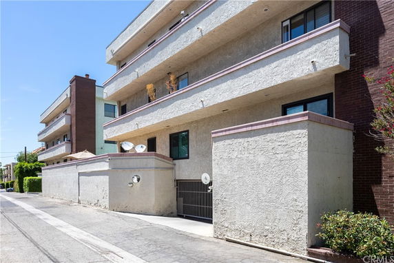 Front view of a multi-story residential building with balconies.
