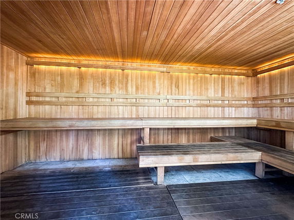 Interior view of a wooden sauna room with seating benches.