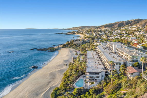 Aerial view of a beachside residential area with buildings overlooking the ocean.