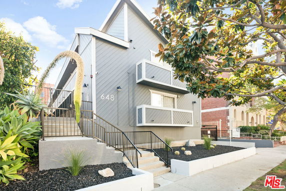 Front view of a multi-story house with unique architectural design and a number displayed on the facade.