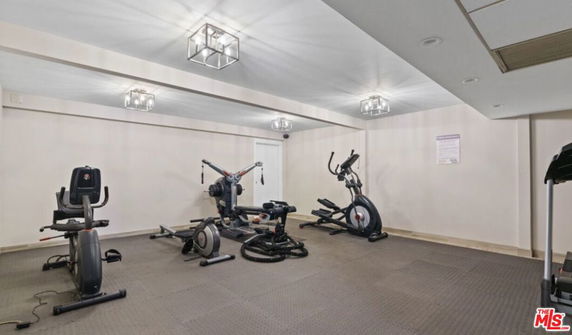 Indoor area with gym equipment including stationary bikes and an elliptical trainer.