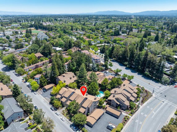 Panoramic view of a residential area with multiple buildings and trees.