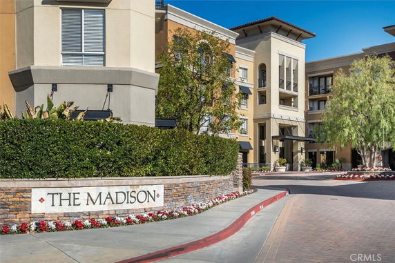 Front view of a multi-story building with decorative landscaping and signage reading 'The Madison'.