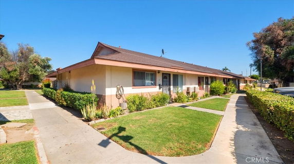 Front view of a single-story house with a landscaped pathway.