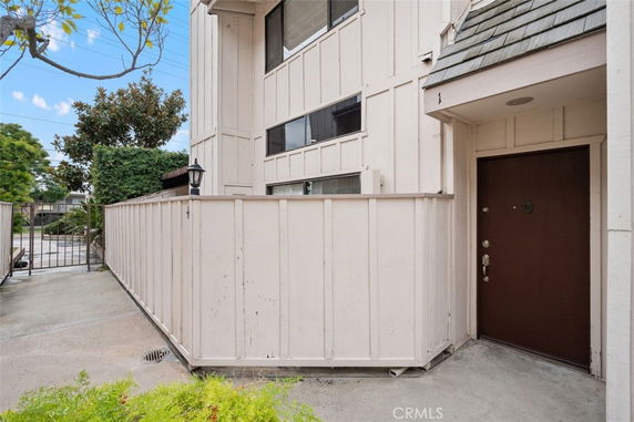 Front view of a two-story building with a gated entrance.