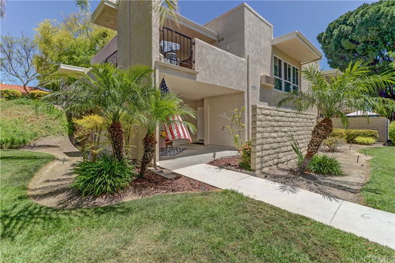 Front view of a two-story house with a balcony and garage.