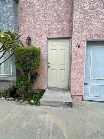 Front view of a house with a single door and textured exterior wall.