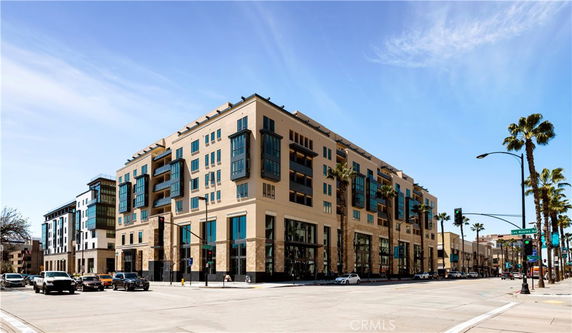 Front view of a multi-story building on a city street corner.