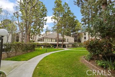 Surrounding view of a building with pathways and trees.