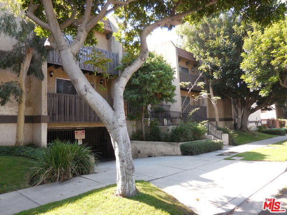 Front view of a multi-story building with balconies.