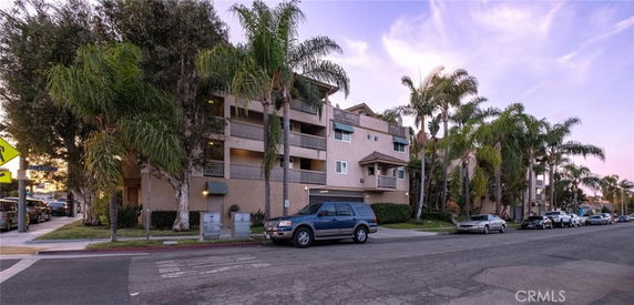 Front view of a multi-story apartment building with balconies.