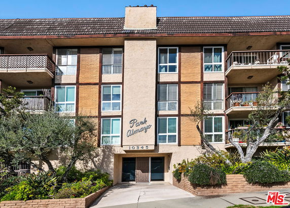 Front view of a multi-story residential building with balconies.