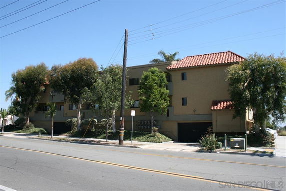 Front view of a multi-story building with a tiled roof.