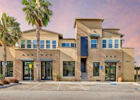 Front view of a two-story modern building with large windows and a central entrance.