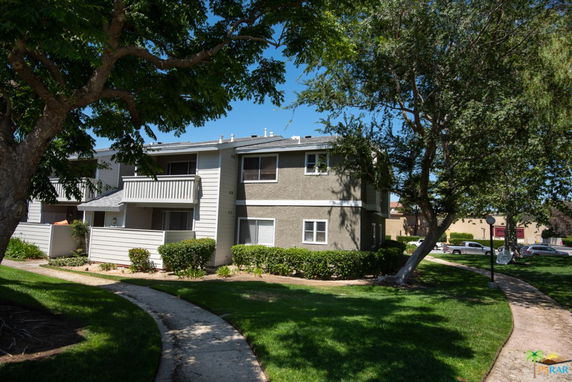 Front view of a two-story apartment building with balconies.