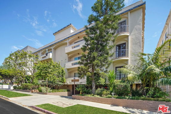 Front view of a multi-story residential building with balconies.