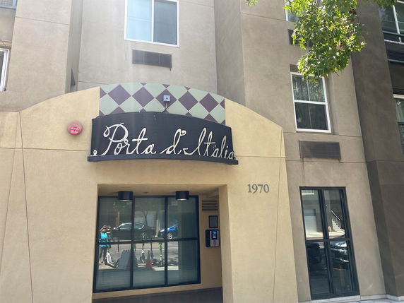 Front view of a building with the name 'Porta d' Italia' above the entrance.