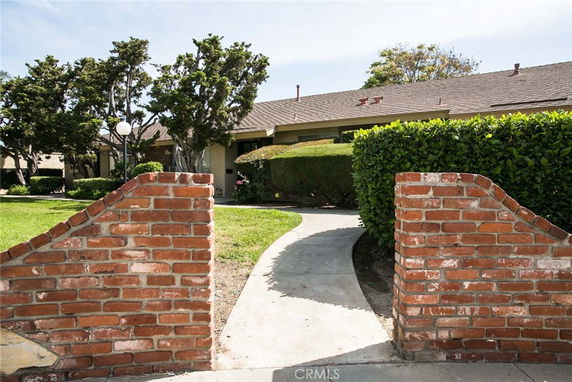Front view of a single-story house with a brick entrance path.