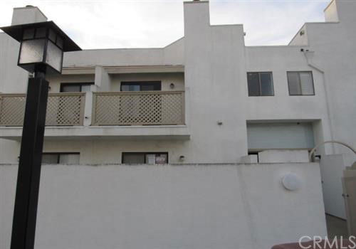 Front view of a multi-story building with balconies and a modern design.