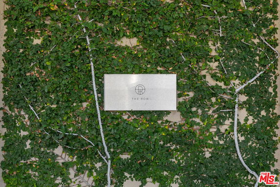 Facade with greenery and a sign labeled 'The Row'.